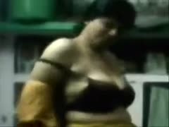 Inside, a plump Indian skank fingers her cum-hole and takes off her clothes.